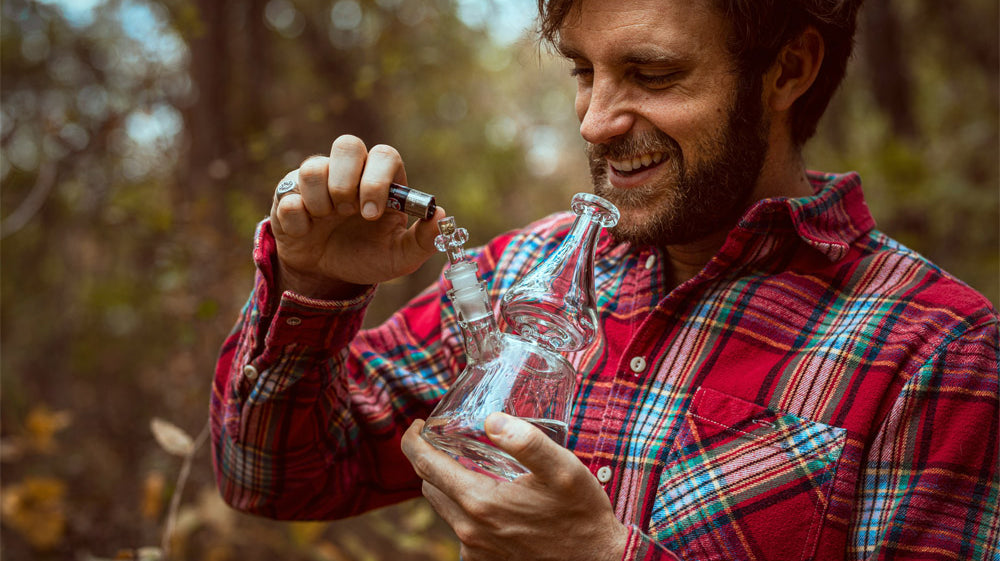 Man smoking a bong outside