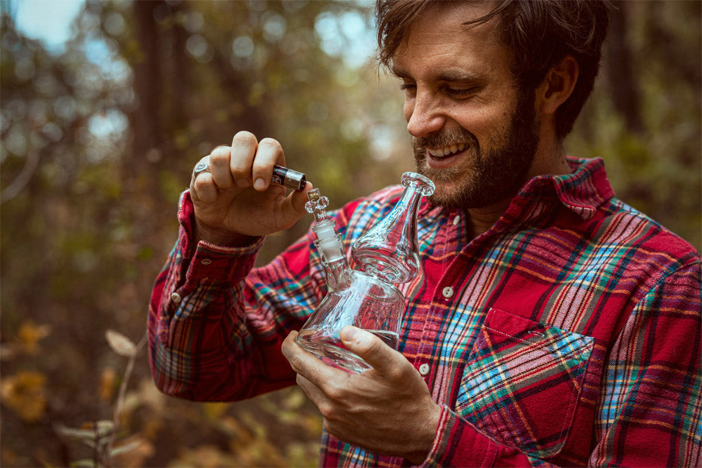 Man smoking a bong outside